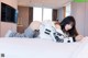 A woman laying on top of a bed next to a television.