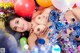 A woman laying on top of a pile of balloons.