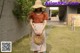 A woman wearing a straw hat and holding a rattan bag.