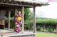 A woman in a kimono standing on a porch.